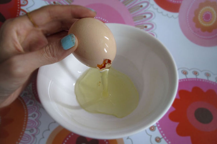 Separate egg white from yolk