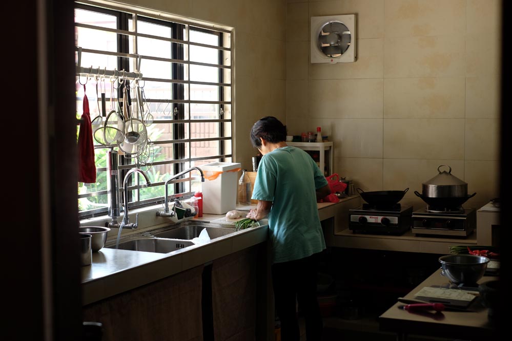 My mother preparing food in the kitchen